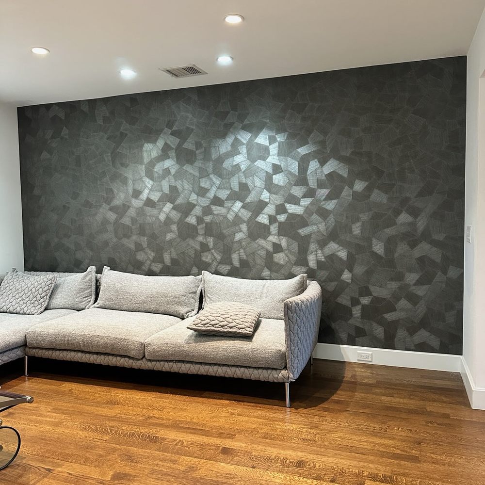 Dark textured wallpaper feature wall in a living room
